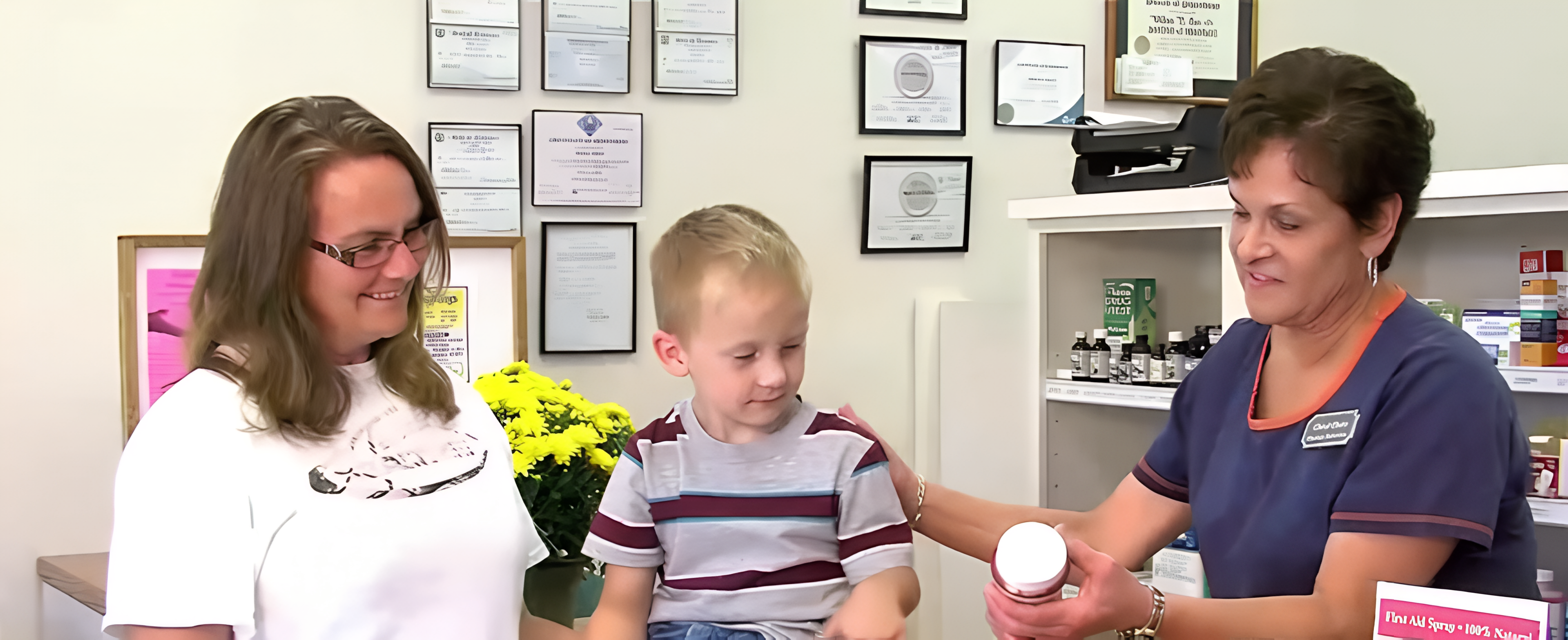 Cave's Drug Store team helping a family at the pharmacy counter